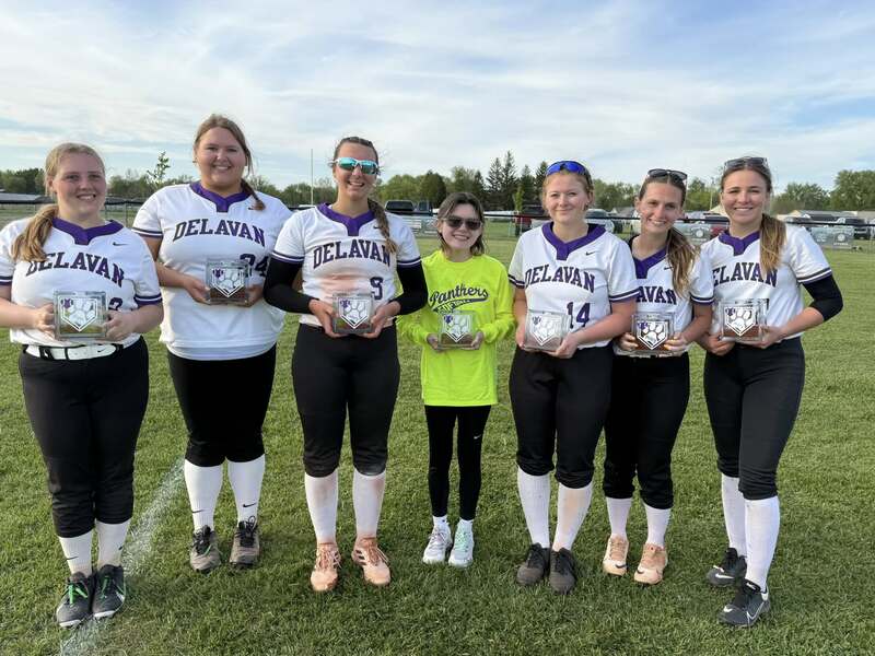 Softball seniors, from left to right, Piper McWhorter, Joselyn Soldal, Lainey Klokkenga, Alyxis Houston, Makenna Diekhoff, Miley Harper, and Jayley Fisher, displaying their gift from the team.