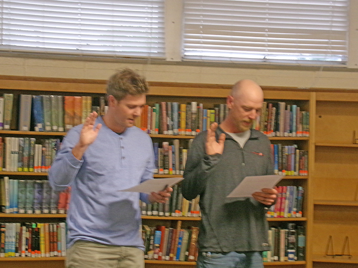 Newly elected board members Brady Wildenradt and  Douglas Lowry being sworn in.