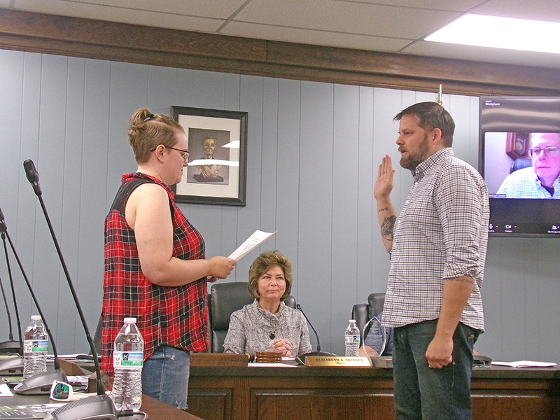 Mayor Elizabeth Skinner looks on as City Clerk Tia Galloway administers the oath of office to Adam White.