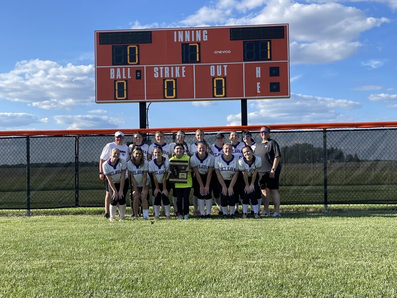 The 2025 Class 1A Regional Champion team posing under their winning scoreboard.