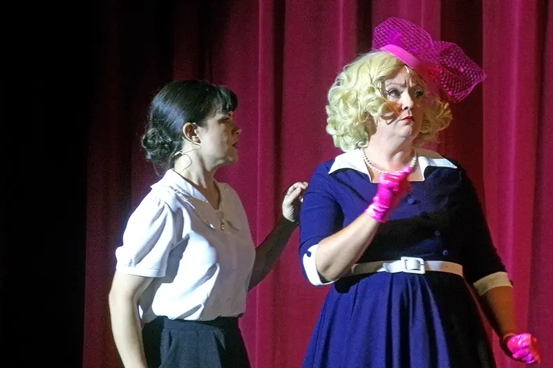 Alison Knapik (left) as Sarah Brown and Jill Usherwood (right) as Miss Adelaide join voices in the spirited duet “Marry the Man Today,” plotting with comic flair to reform their suitors after vows are exchanged.