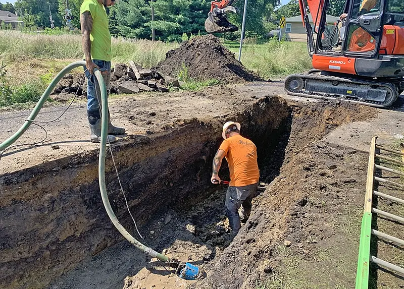Crew members from G.A. Rich & Sons Plumbing work to repair a leaking water main near the intersection of 8th and Cedar Streets in Delavan on Tuesday afternoon. The joint effort with city crews restored service and limited disruption to nearby residents.