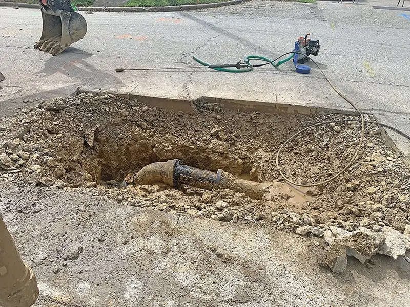 City crews expose the ruptured cast-iron water line on Locust Street, where aging infrastructure gave way under pressure, triggering Delavan’s second main break in a week.