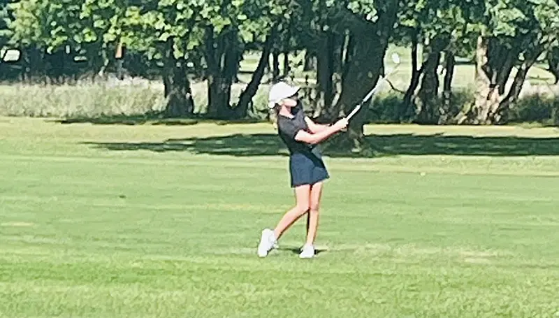 Tenley Burrell lines up a clean shot from the fairway with her iron during a round at the sectional tournament. The Delavan eighth grader’s steady form and focus helped propel her to a 24th-place finish at the IESA State Golf Tournament.