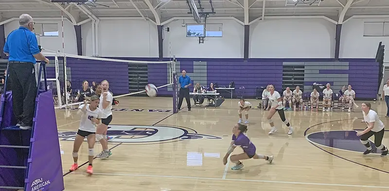 Sophomore Willow Gomez stretches low for one of her season-high 11 digs during Tuesday’s clash with Illini Bluffs, anchoring Delavan’s defense.