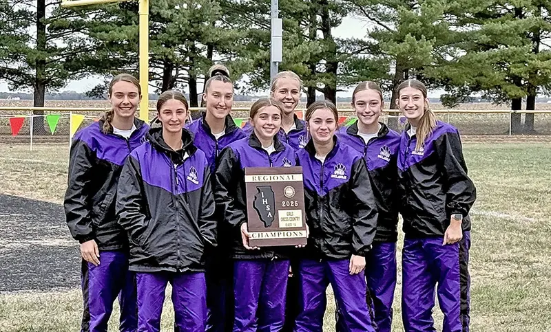 The Delavan High School Girls Cross Country Team beams with pride after capturing the 2025 IHSA Regional Championship—marking a historic victory fueled by record-breaking runs and unstoppable team spirit. 