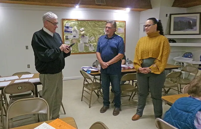 Membership Drive Chairperson Steven Skinner (left) administers the Optimist Club oath to new members Pat Woiwode (center) and Alicia Parsons (right) during the club’s November 13 meeting.