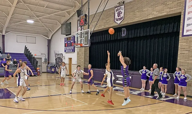 Freshman Micah Berfield leaps to contest a three-point shot from sophomore Drake Neuendorf during the Panthers’ spirited scrimmage at “Meet the Panthers” night.