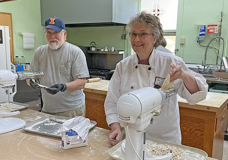 Ed Allen and Sally Lessen roll out another batch of homemade noodles—fueling one of Delavan’s most cherished holiday traditions.