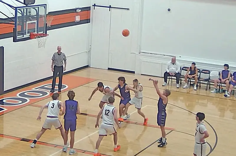 Grady Burrell (#10) fires a swish from the free-throw line as Hudson Briggs (#14) and Hunter Lusher (#21) position for the rebound during Friday’s ICAC matchup against Elmwood.