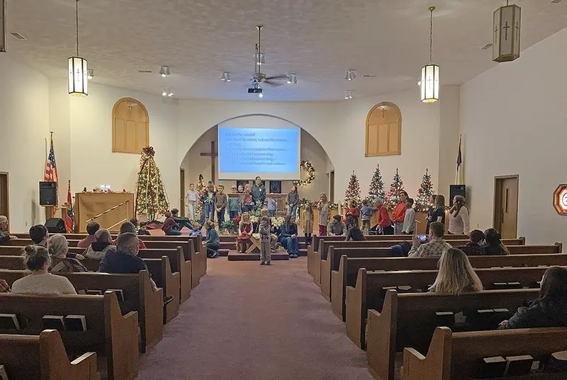 Awana participants and attendees lift their voices in a joyful rendition of ‘Joy to the World’ to conclude the Delavan Baptist Church Christmas program, celebrating the arrival of the Christ-child.