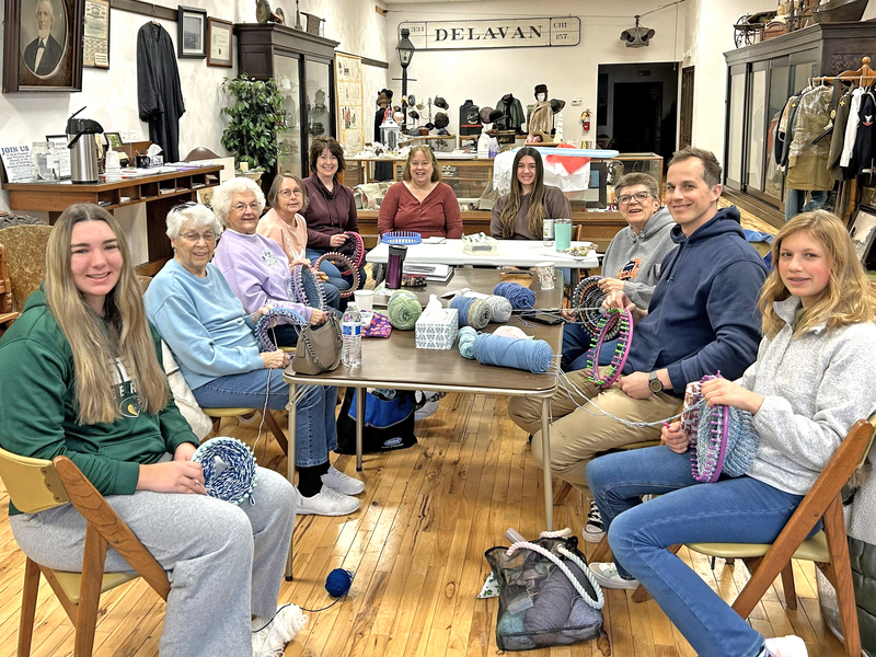 photo courtesy of Mary ruth lowry
From left: Lainey Klokkenga, Liz Fortney, Janice Allgood, Julie Hopkins, Karla Carr, Ellen McConnell, McKealey Klokkenga, Gail Strunk, Mark Griffith, and Avery Griffith of the Delavan CroKnits gather for their first workday of the year. Not pictured: Mary Ruth Lowry.