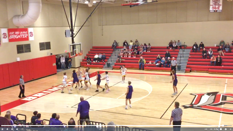 Hunter Lusher (21) muscles back up after his own rebound, finishing strong under the rim for 2 points.