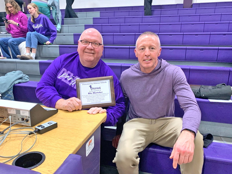 Ric Hartzler (left) proudly displays his recognition plaque alongside Delavan Athletic Director Ryon Kramer (right).