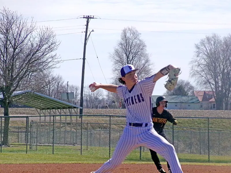 Mid?delivery, Hunter Lusher powers through his stride as he fires toward the plate.