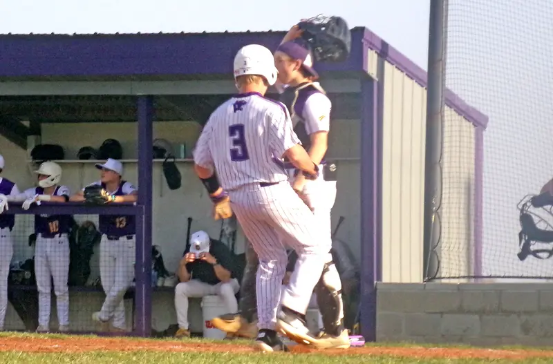 Grady Burrell races across home plate to put Delavan on the board against the Peoria Christian Chargers during Monday’s matchup.