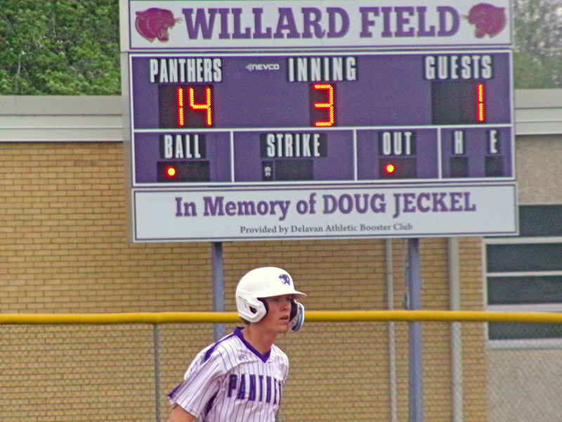 With the scoreboard showing Delavan’s dominant advantage, Corie Green takes his lead off second during Friday’s rout of IC/Hartem.
