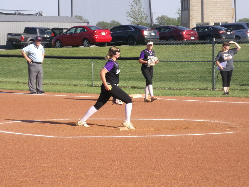 Maddie Lowers locks in on the mound, gearing up to fire the next pitch as Addi Fisher stands ready at first, poised for whatever comes her way.