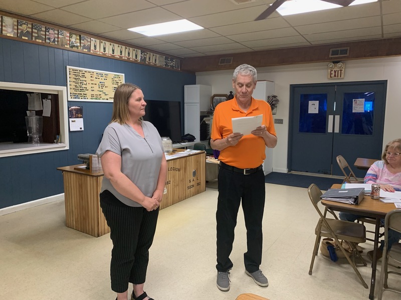 Optimist Club Membership Director Steve Skinner administers the oath of membership to new inductee Jennifer Burrell during the club’s May 14 meeting.