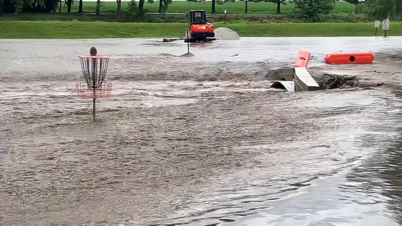 Floodwaters engulf  Delavan’s Lake Park, washing over the Linden Street bridge project and setting back days of progress in a matter of hours.