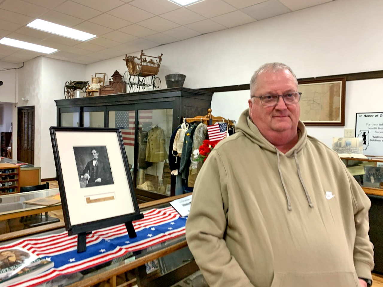 Mark Walsh displays a framed copy of Abraham Lincoln’s signature at the Delavan Historical Society. Walsh’s research into the signature’s origins uncovered a connection between his family, the historic Phillips House hotel, and Lincoln’s visits to Delavan.