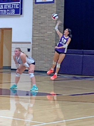 Delavan’s Mia Mammen readies for a defensive return as teammate Mckinzey Ring delivers a serve during the Panthers’ straight-set victory over Peoria Manual on Sept. 14 in Delavan.